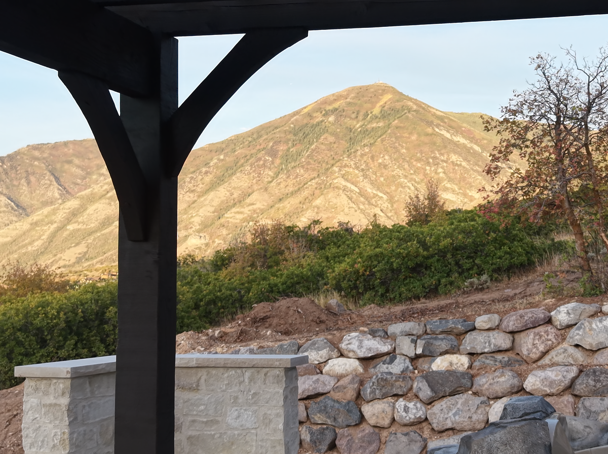 A braced corner post of the Cordovan Brown pergola with a mountain peak behind, Elk Ridge, Utah
